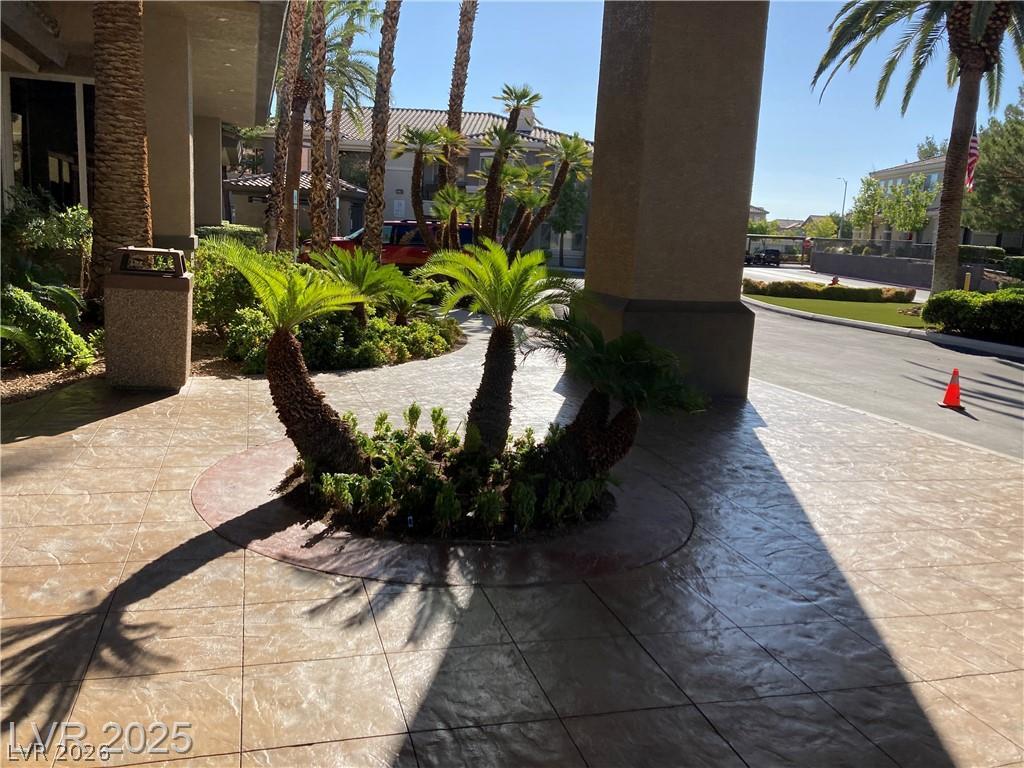 9050 West Warm Springs Road, Unit 1027 Las Vegas, NV 89148 - Photo 39 of 44 A grand entrance welcomes residents with meticulously stamped concrete pathways and lush palm landscaping.