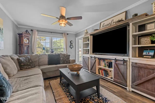 a view of a livingroom with furniture and a hallway
