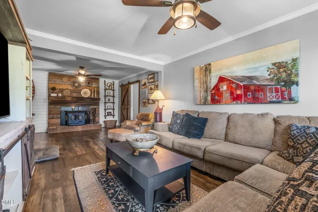 a bedroom with a bed a chandelier and dresser