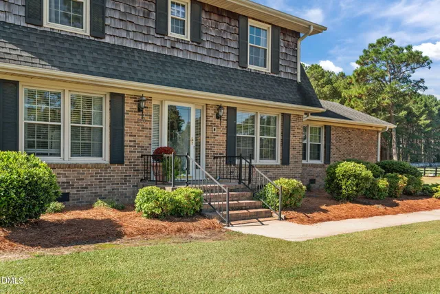 a front view of a house with garden and porch