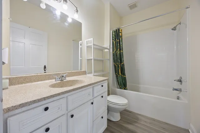 a view of a dining room with furniture wooden floor and a chandelier