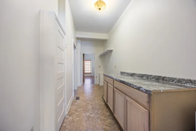 a bedroom with a bed couch and a window