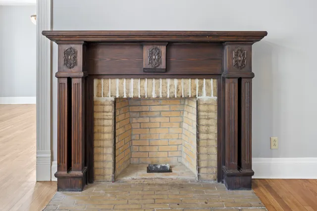 a view of a room with wooden floor lounge chair and windows