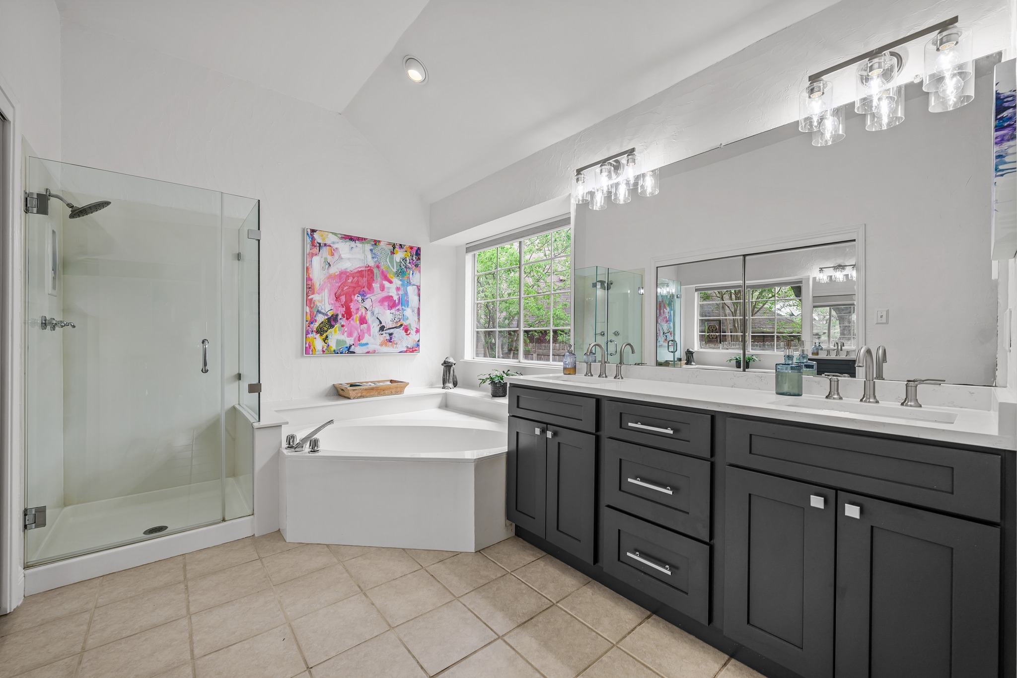 4801 Counts Cove Austin, TX 78749 - Photo 19 of 40 Full bath with double vanity, lofted ceiling, a stall shower, a bath, and light tile patterned flooring