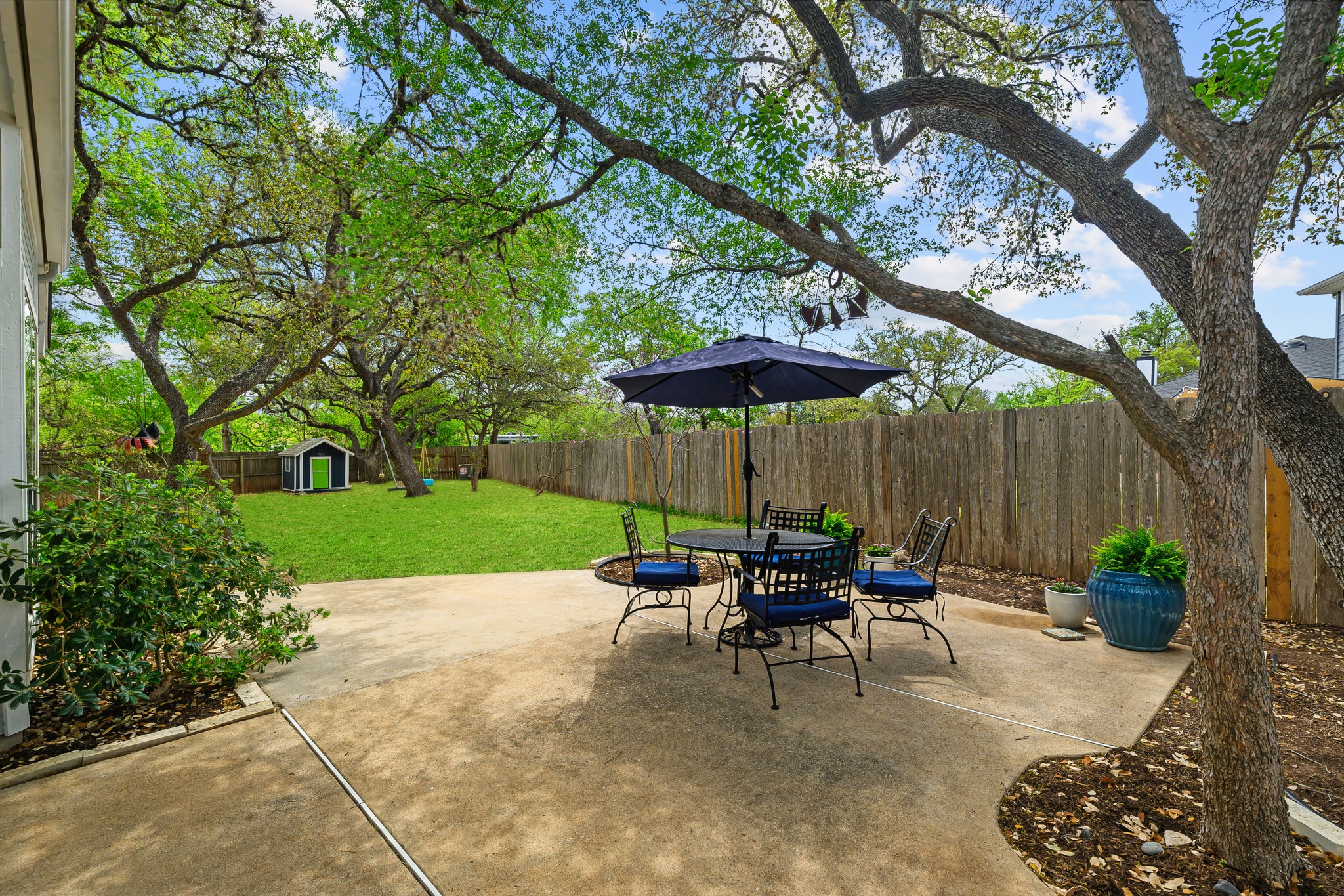 4801 Counts Cove Austin, TX 78749 - Photo 25 of 40 a view of a table and chairs under an umbrella in backyard