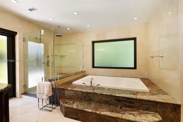 a bathroom with a bathtub and a shower