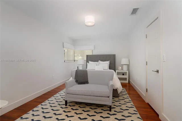 a bedroom with a bed and a rug