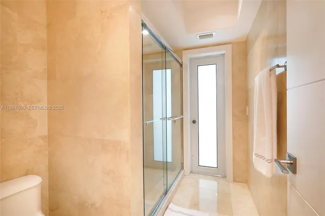 a view of a bathroom from a hallway