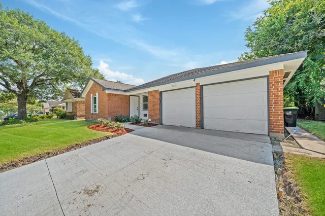 a view of a house with a yard and garage