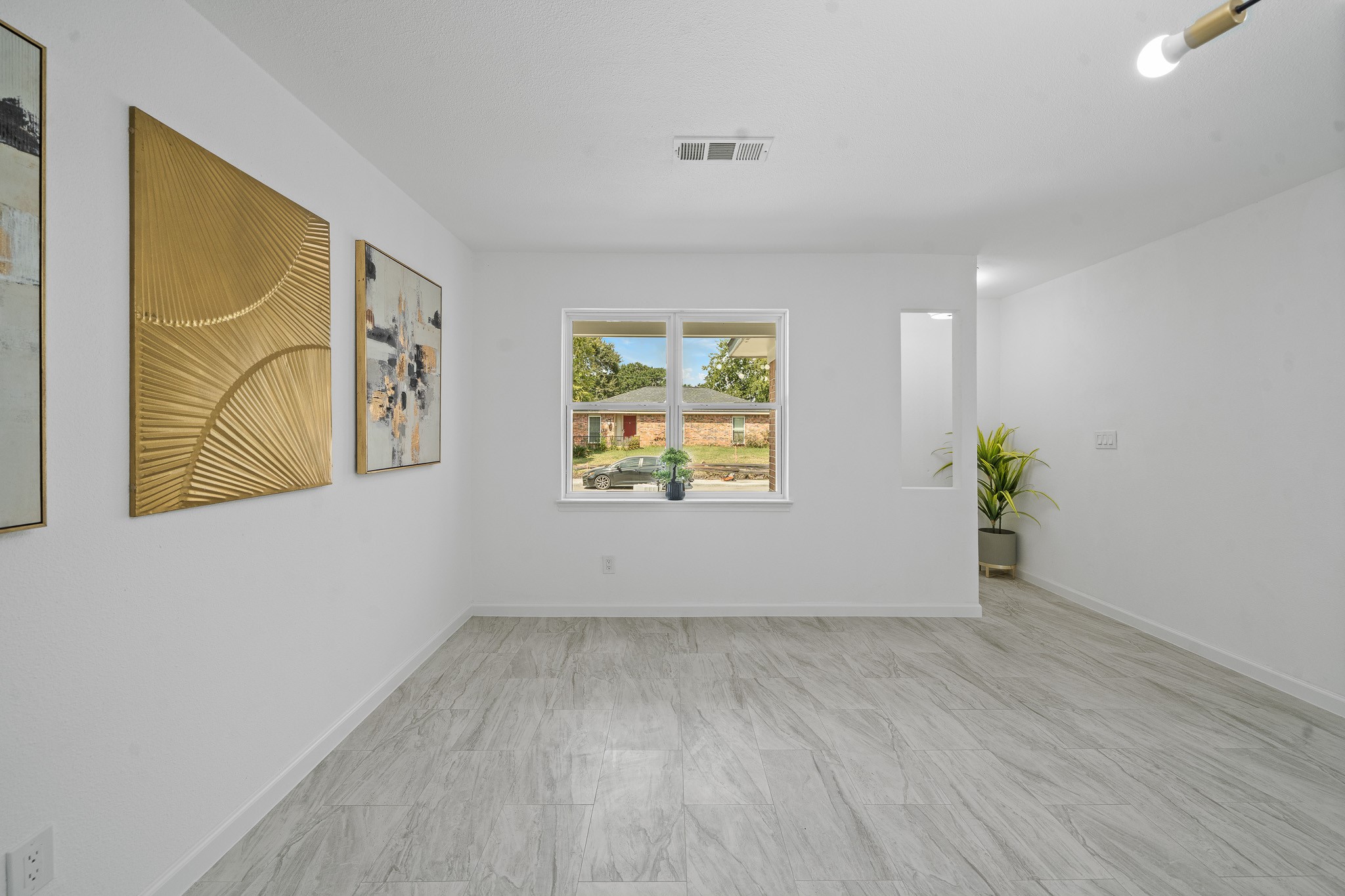15415 West Hampton Circle Houston, TX 77071 - Photo 12 of 35 an empty room with windows and wooden floor