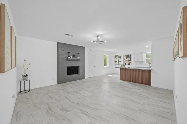 a view of a kitchen with a sink and a refrigerator