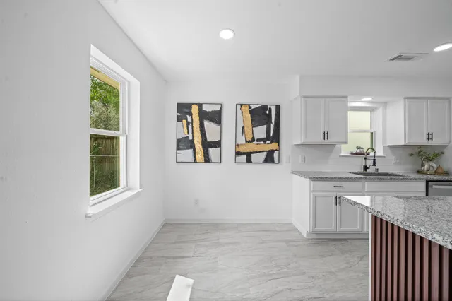 a kitchen with stainless steel appliances granite countertop a stove a sink and a microwave