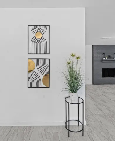 a bathroom with a sink a mirror and a potted plant
