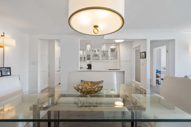 a dining room with furniture a chandelier and wooden floor