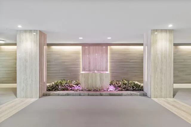 a view of a kitchen with kitchen island wooden floors granite counter tops and a counter space