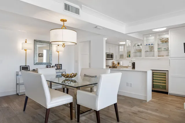 a open kitchen with white cabinets and stainless steel appliances