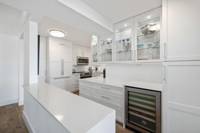 a kitchen with a sink a stove top oven and cabinets
