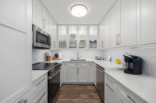 a kitchen with a sink and microwave