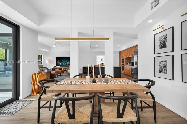 a kitchen with granite countertop white cabinets and stainless steel appliances