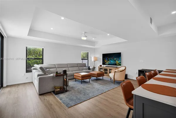 a bedroom with a bed a bookshelf and a bookshelf with wooden floor