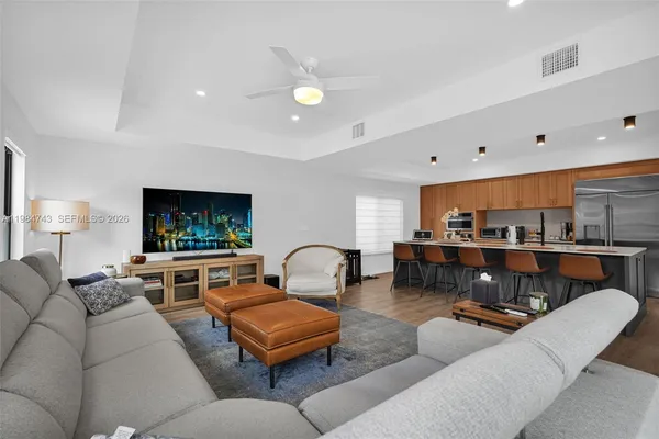 a view of entryway and hall with wooden floor