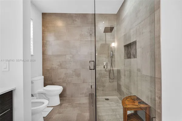 a view of a house with a ceiling fan and a wooden floor