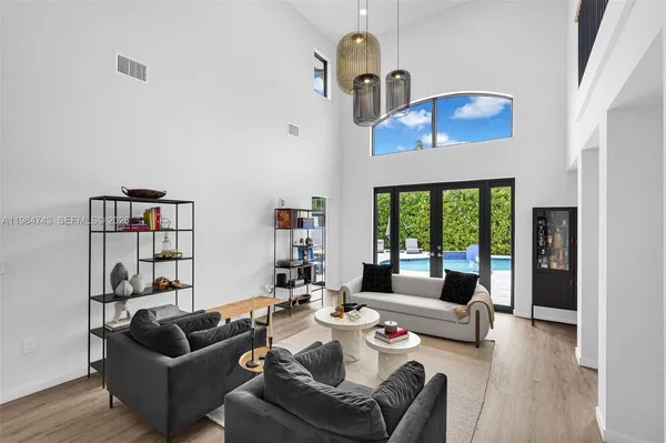a living room with furniture fireplace and a large window