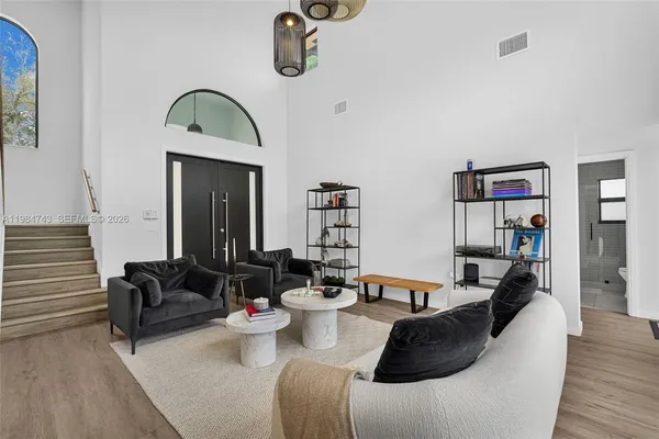 a view of a dining room with furniture and wooden floor