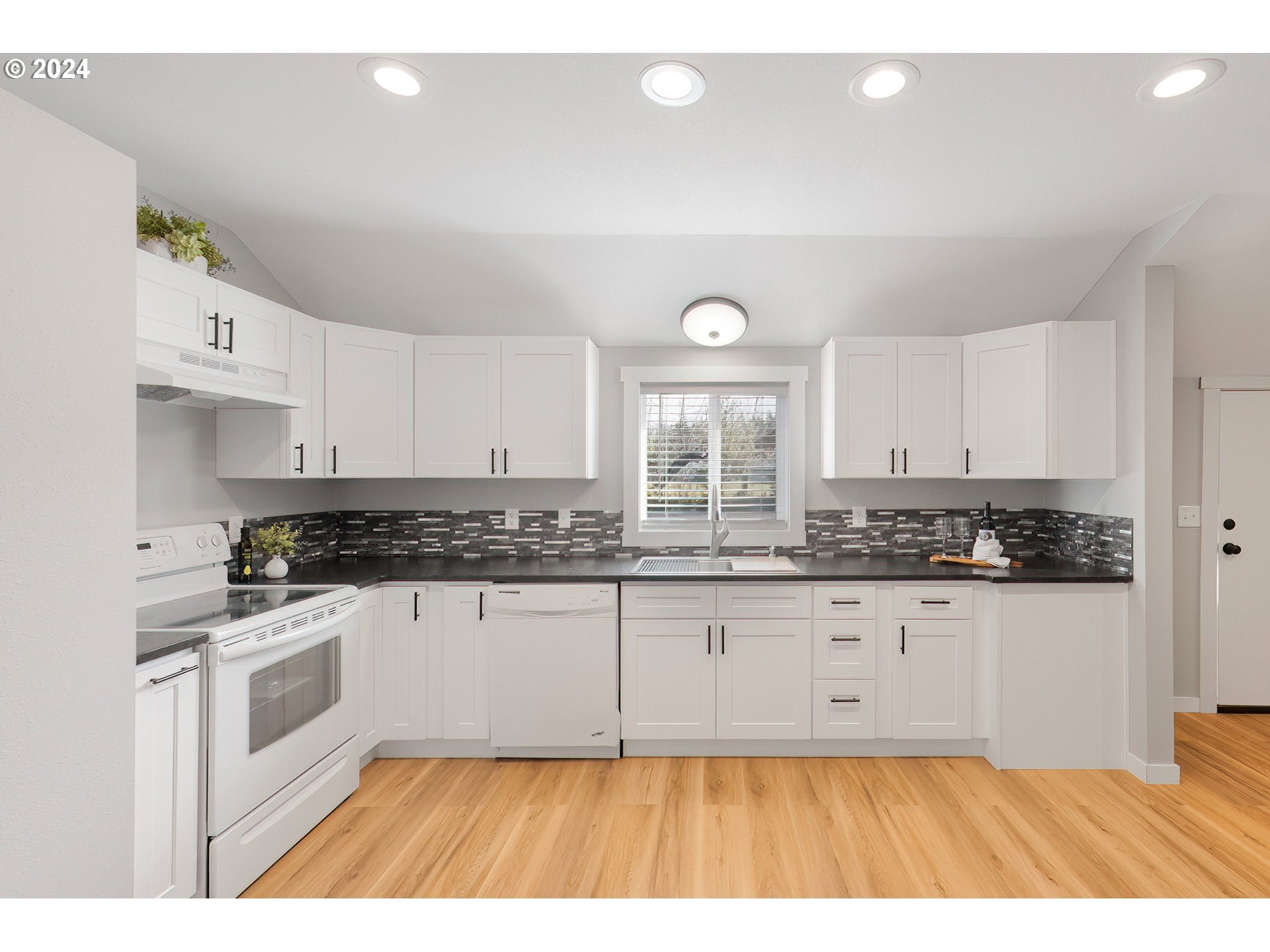 128 Eadon Road Toledo, WA 98591 - Photo 11 of 35 a kitchen with granite countertop a stove a sink dishwasher and a refrigerator