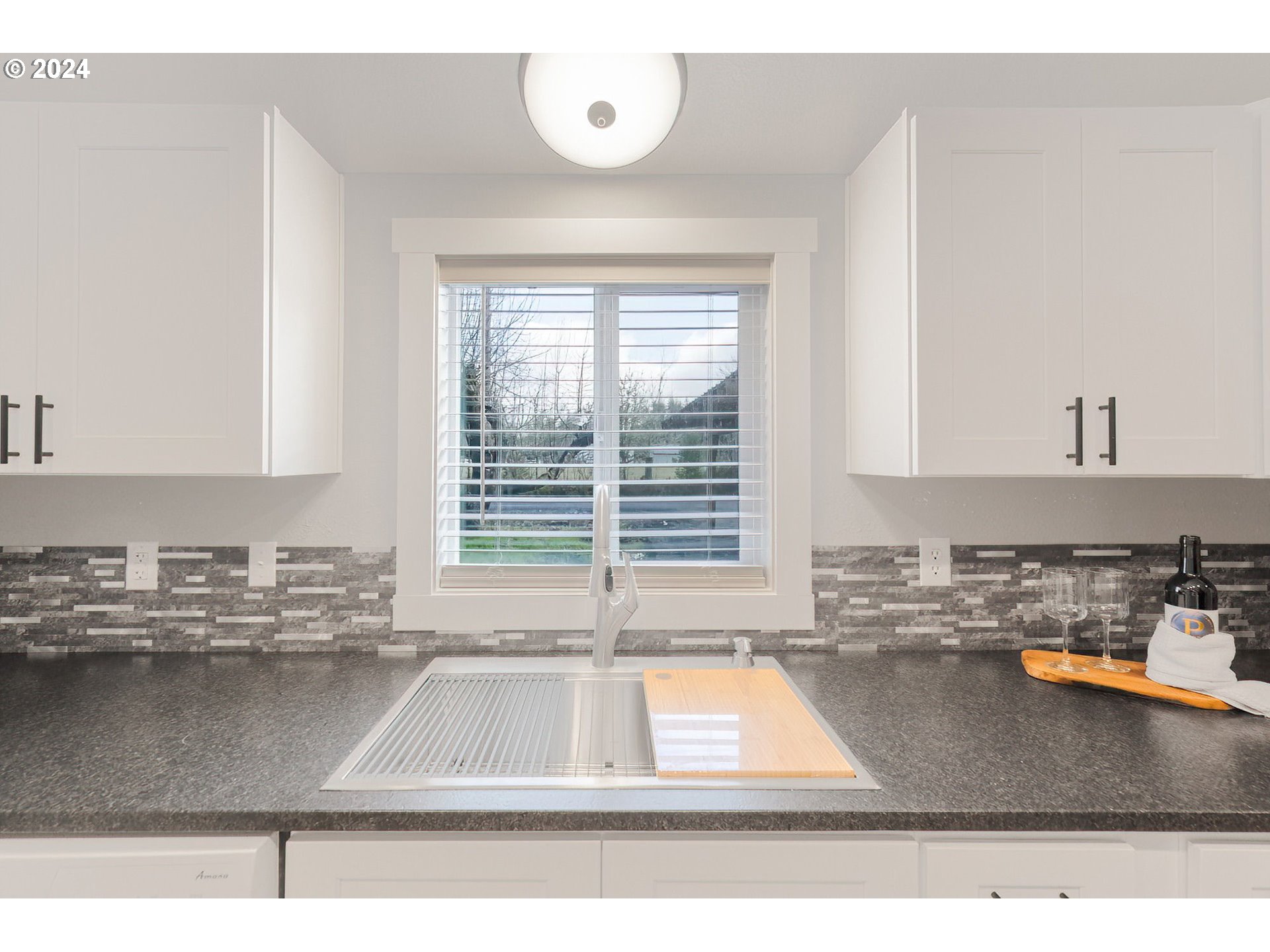 128 Eadon Road Toledo, WA 98591 - Photo 13 of 35 a kitchen with kitchen island a large window a sink and a counter top space