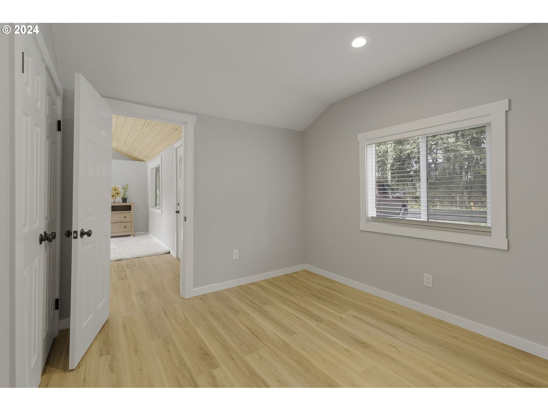 128 Eadon Road Toledo, WA 98591 - Photo 9 of 35 a view of an empty room with wooden floor and a window