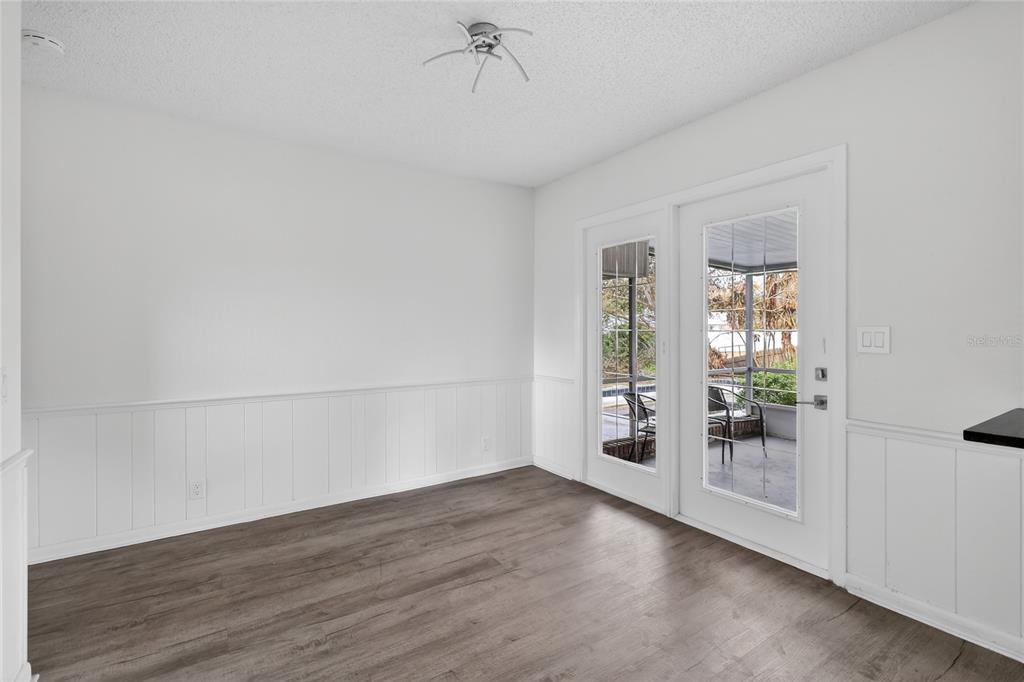 148 Lake Otis Road Winter Haven, FL 33884 - Photo 15 of 44 an empty room with wooden floor and windows