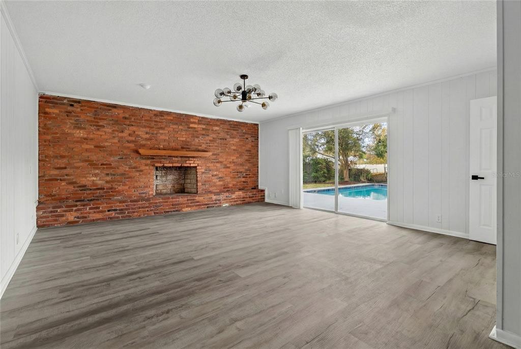 148 Lake Otis Road Winter Haven, FL 33884 - Photo 16 of 44 a view of an empty room with a window and wooden floor