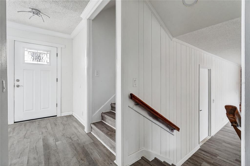 148 Lake Otis Road Winter Haven, FL 33884 - Photo 17 of 44 a view of a hallway with wooden floor and staircase
