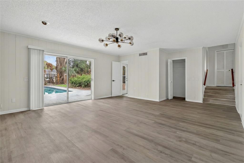 148 Lake Otis Road Winter Haven, FL 33884 - Photo 18 of 44 a view of a livingroom with wooden floor and a ceiling fan