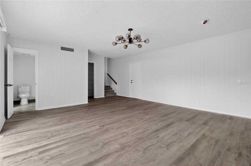 148 Lake Otis Road Winter Haven, FL 33884 - Photo 20 of 44 an empty room with wooden floor and windows
