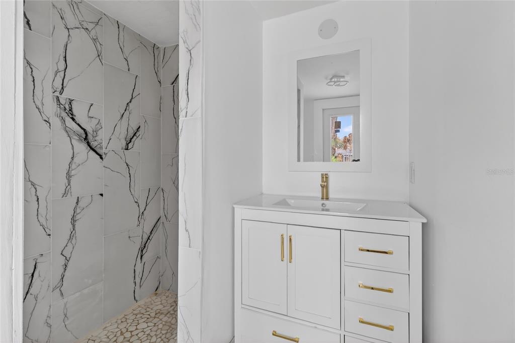 148 Lake Otis Road Winter Haven, FL 33884 - Photo 21 of 44 a bathroom with a granite countertop sink a vanity and a mirror