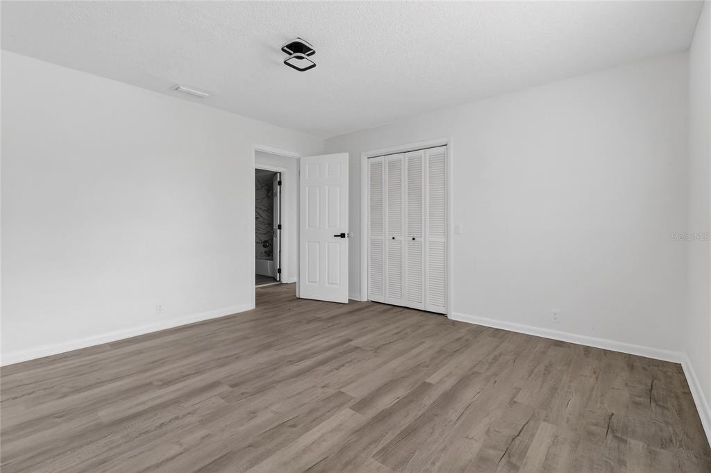 148 Lake Otis Road Winter Haven, FL 33884 - Photo 22 of 44 a view of an empty room with wooden floor