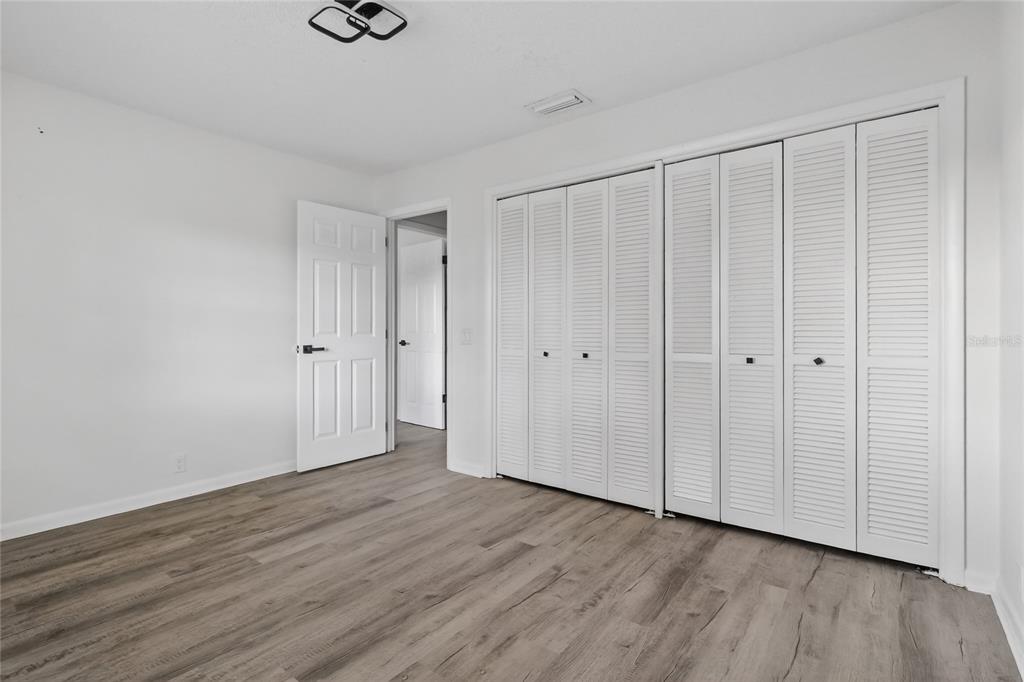 148 Lake Otis Road Winter Haven, FL 33884 - Photo 29 of 44 a view of an empty room with wooden floor