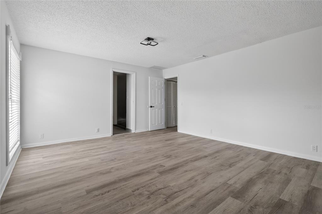 148 Lake Otis Road Winter Haven, FL 33884 - Photo 31 of 44 a view of an empty room with wooden floor