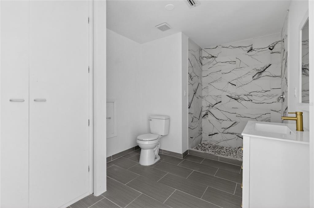 148 Lake Otis Road Winter Haven, FL 33884 - Photo 33 of 44 a bathroom with a toilet and a shower curtain