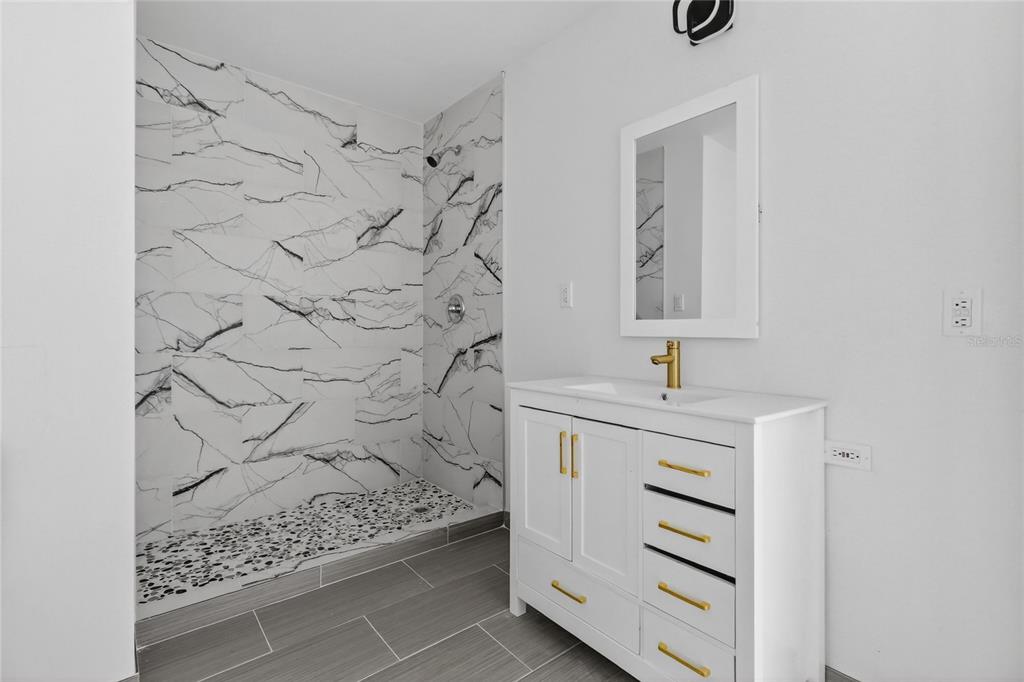 148 Lake Otis Road Winter Haven, FL 33884 - Photo 34 of 44 a bathroom with a sink and a mirror