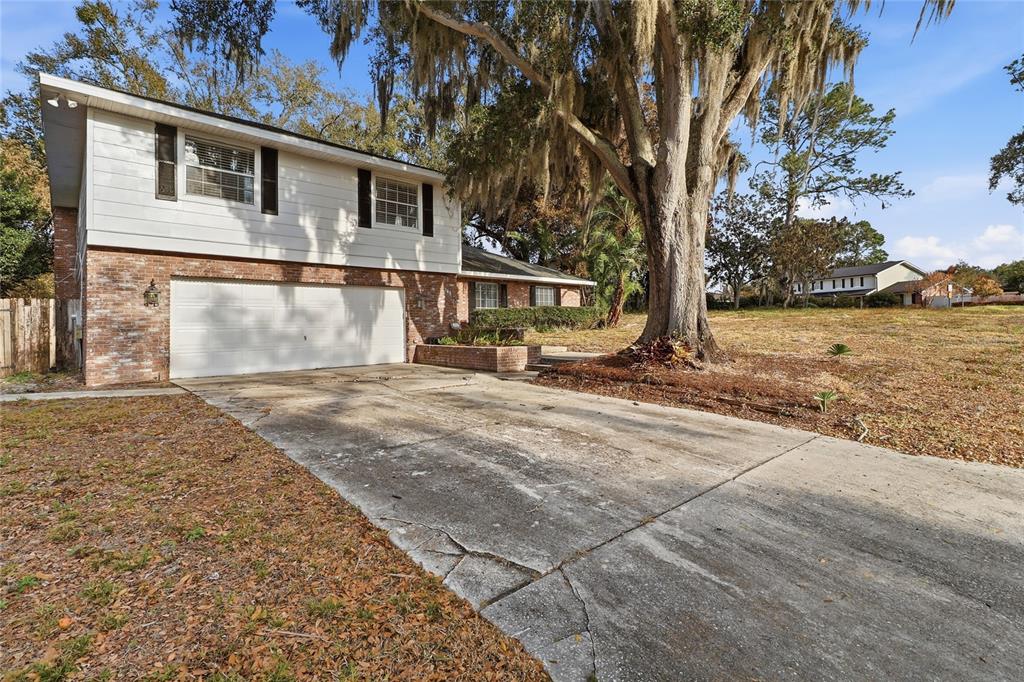 148 Lake Otis Road Winter Haven, FL 33884 - Photo 4 of 44 a front view of a house with a yard