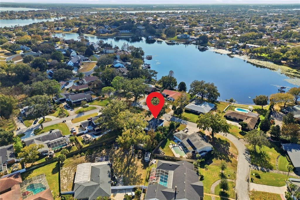 148 Lake Otis Road Winter Haven, FL 33884 - Photo 43 of 44 an aerial view of lake and residential houses with outdoor space