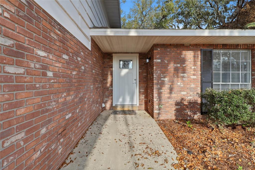 148 Lake Otis Road Winter Haven, FL 33884 - Photo 5 of 44 a view of a brick house with a large window