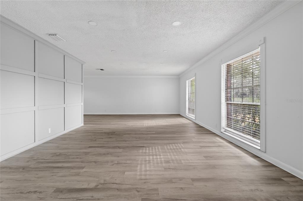 148 Lake Otis Road Winter Haven, FL 33884 - Photo 6 of 44 a view of an empty room with wooden floor and a window