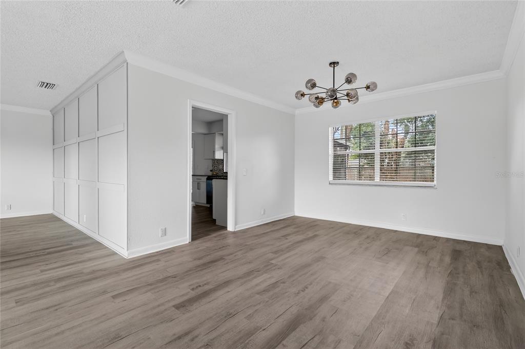148 Lake Otis Road Winter Haven, FL 33884 - Photo 7 of 44 a view of an empty room with a window and wooden floor