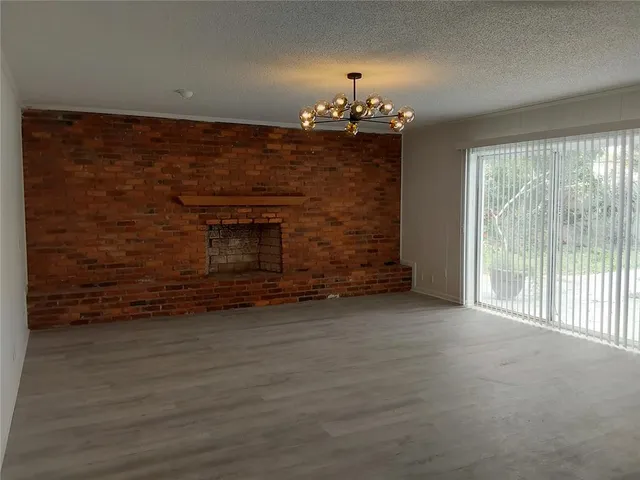 a view of an empty room with a fireplace