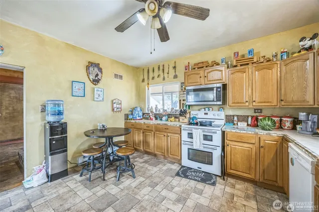 a kitchen with a cabinets and chairs