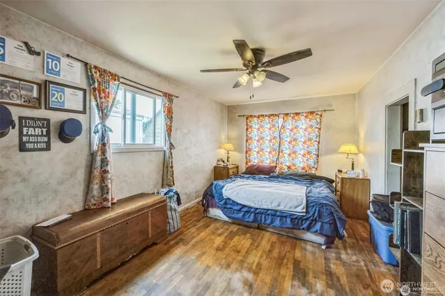 a spacious bedroom with a bed and a large window